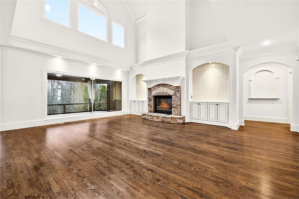 2910 Creek Tree Lane Cumming, GA 30041 - Photo 19 of 75 a view of empty room with wooden floor and fireplace