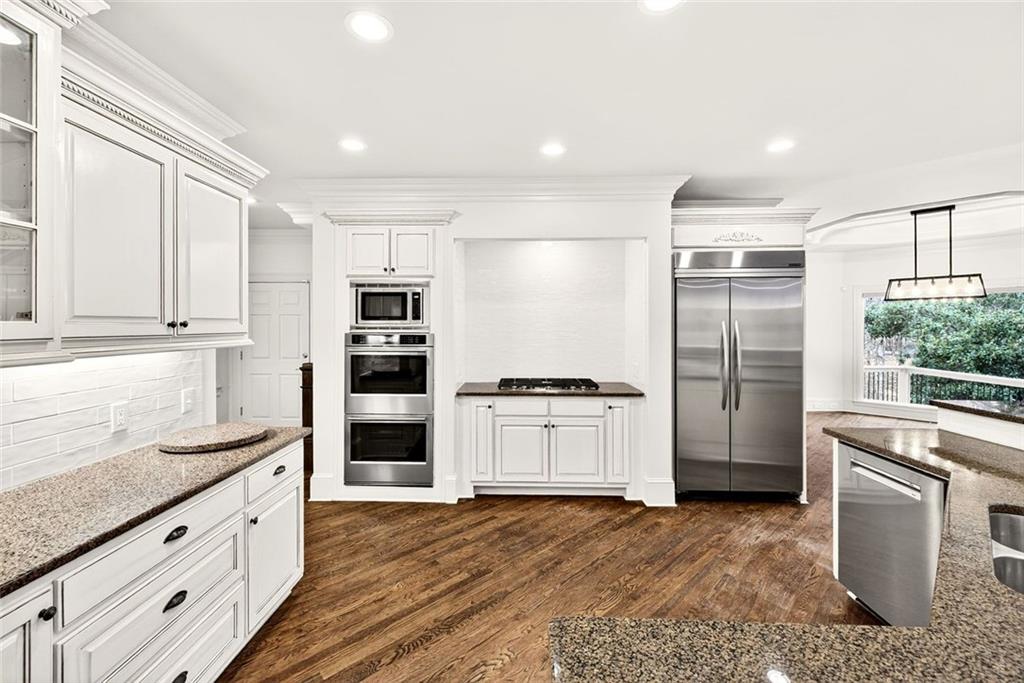 2910 Creek Tree Lane Cumming, GA 30041 - Photo 23 of 75 a kitchen with granite countertop white cabinets and stainless steel appliances