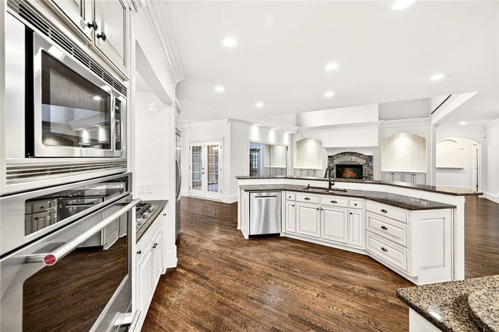 2910 Creek Tree Lane Cumming, GA 30041 - Photo 25 of 75 a kitchen with stainless steel appliances granite countertop a stove and a sink
