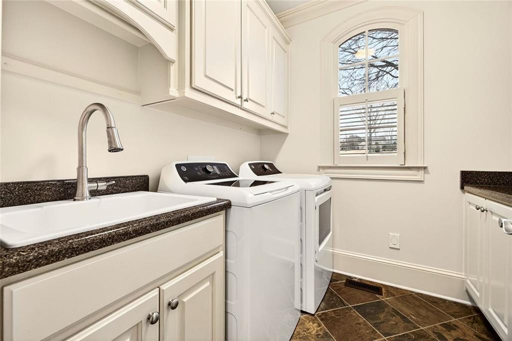 2910 Creek Tree Lane Cumming, GA 30041 - Photo 28 of 75 a utility room with sink dryer and washer
