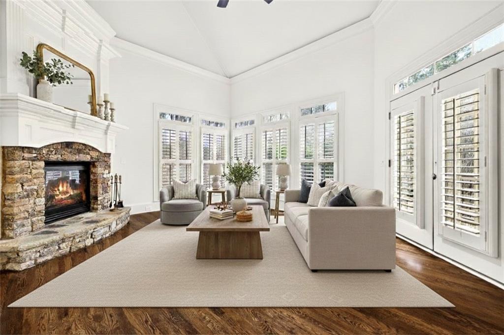 2910 Creek Tree Lane Cumming, GA 30041 - Photo 31 of 75 a living room with furniture large window and a fireplace