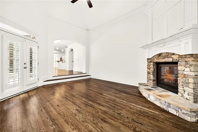 a bathroom with a granite countertop sink a toilet and a mirror