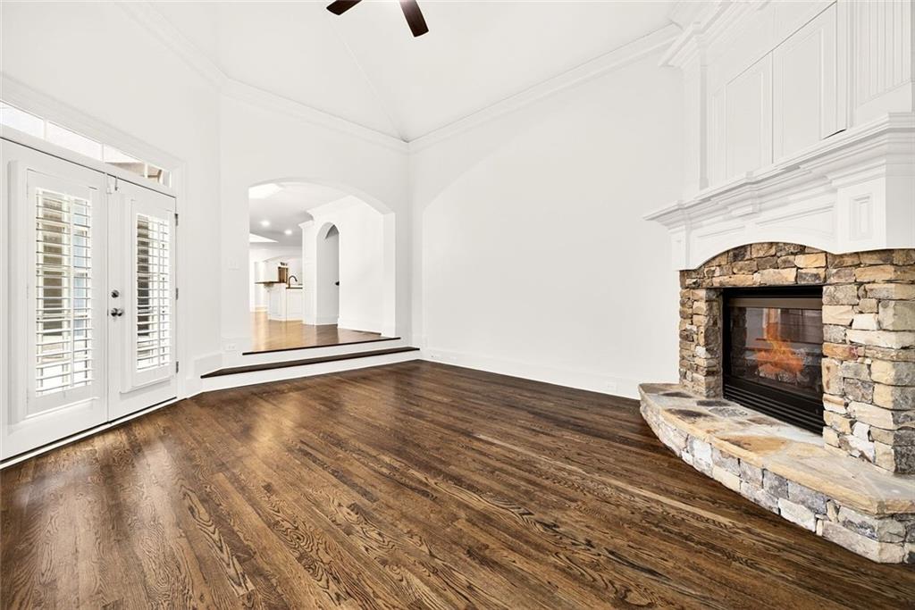2910 Creek Tree Lane Cumming, GA 30041 - Photo 33 of 75 a view of an empty room with wooden floor and a fireplace