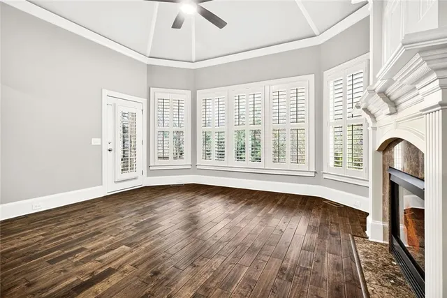 a bathroom with a granite countertop sink a toilet a mirror and bathtub