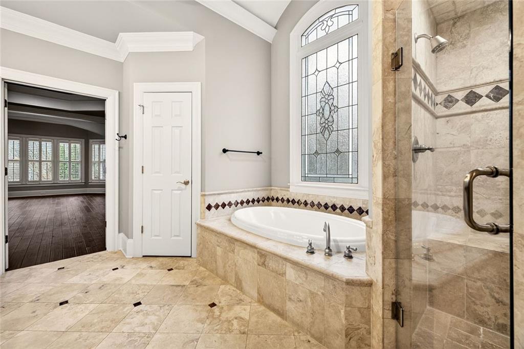 2910 Creek Tree Lane Cumming, GA 30041 - Photo 41 of 75 a bathroom with a bathtub and a shower