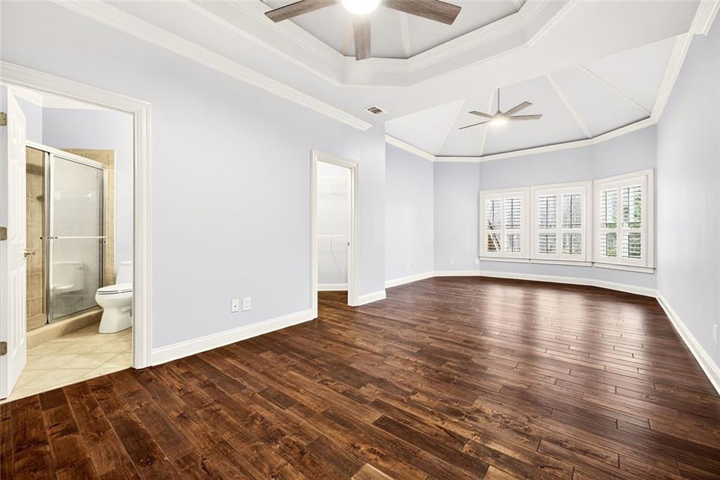 2910 Creek Tree Lane Cumming, GA 30041 - Photo 44 of 75 a view of empty room with wooden floor and fan