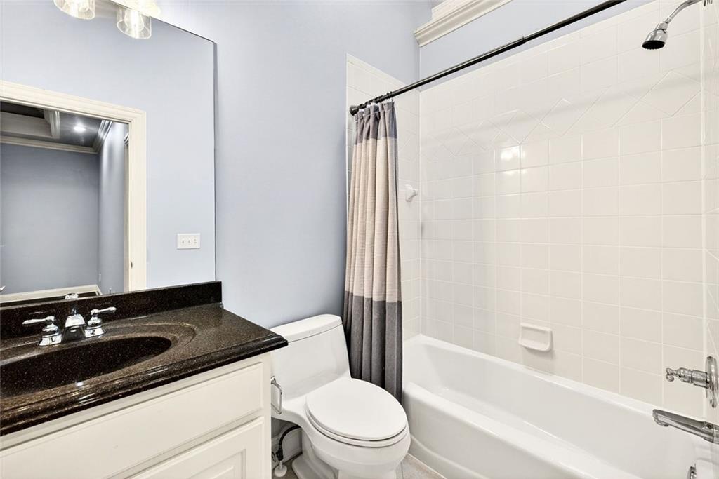 2910 Creek Tree Lane Cumming, GA 30041 - Photo 49 of 75 a bathroom with a sink a toilet a mirror and shower