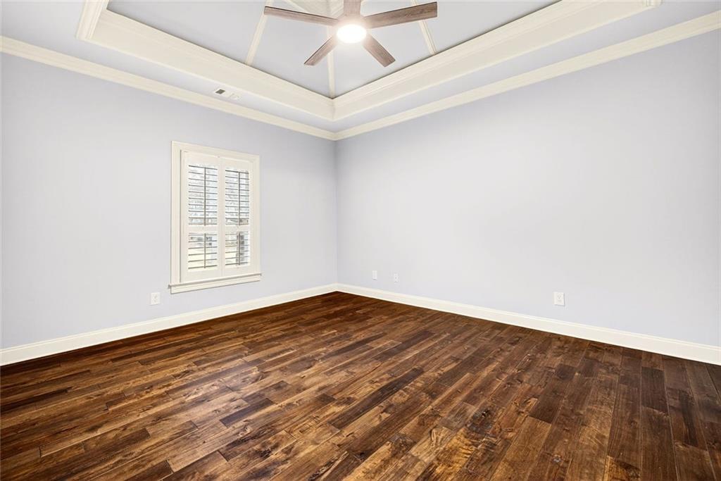 2910 Creek Tree Lane Cumming, GA 30041 - Photo 50 of 75 an empty room with wooden floor and windows