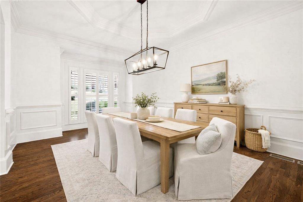 2910 Creek Tree Lane Cumming, GA 30041 - Photo 6 of 75 a dining room with furniture a chandelier and wooden floor