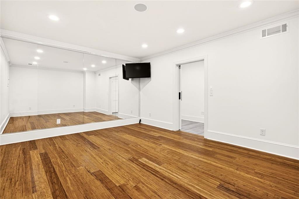 2910 Creek Tree Lane Cumming, GA 30041 - Photo 64 of 75 a view of an empty room with wooden floor