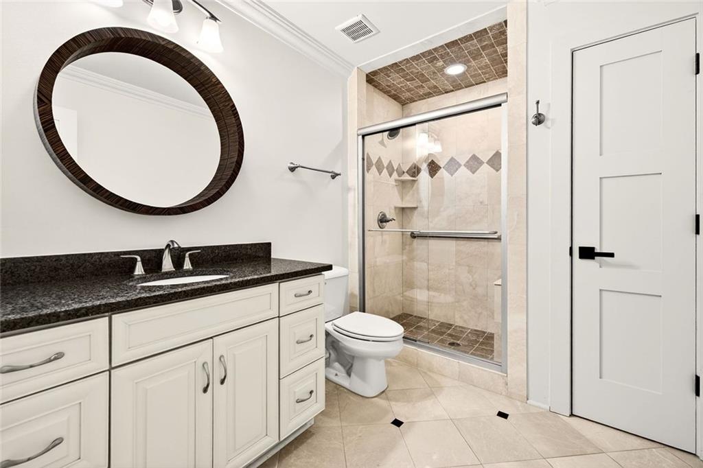 2910 Creek Tree Lane Cumming, GA 30041 - Photo 66 of 75 a bathroom with a toilet a sink and a mirror