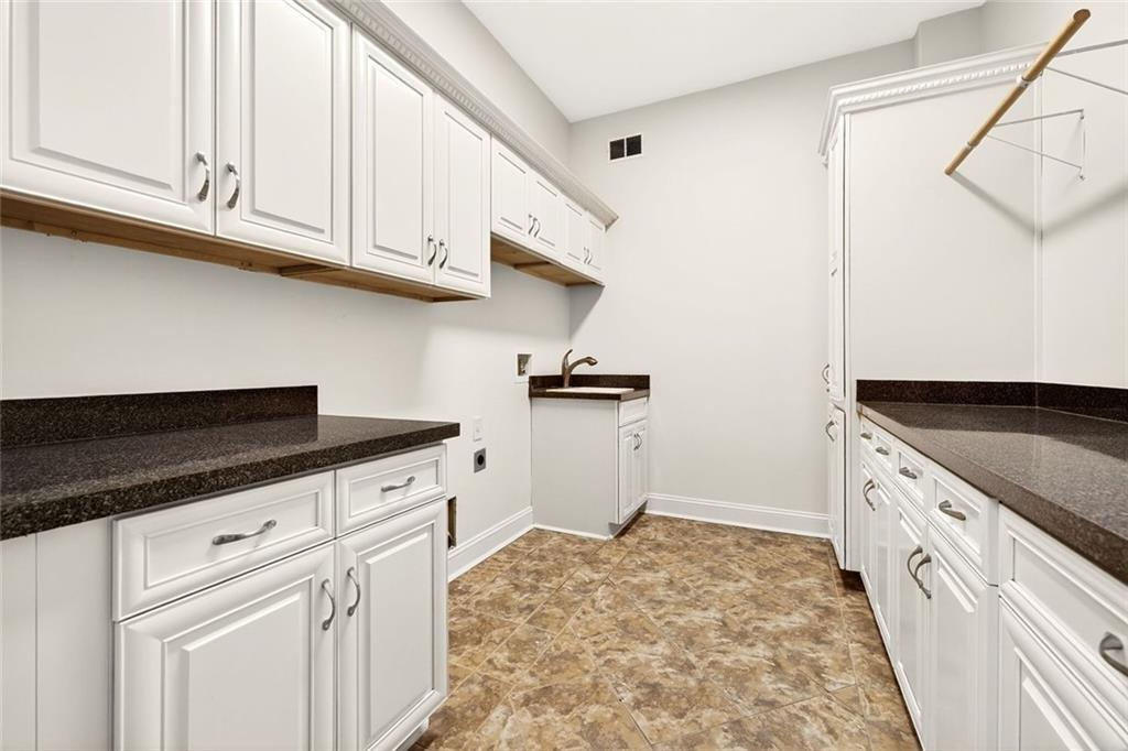 2910 Creek Tree Lane Cumming, GA 30041 - Photo 68 of 75 a kitchen with granite countertop a sink and a stove