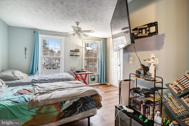 a bedroom with a bed a table and chair