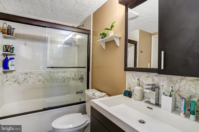 a bathroom with a sink toilet and mirror