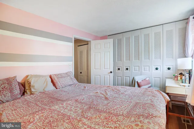 a bedroom with a large bed and a closet