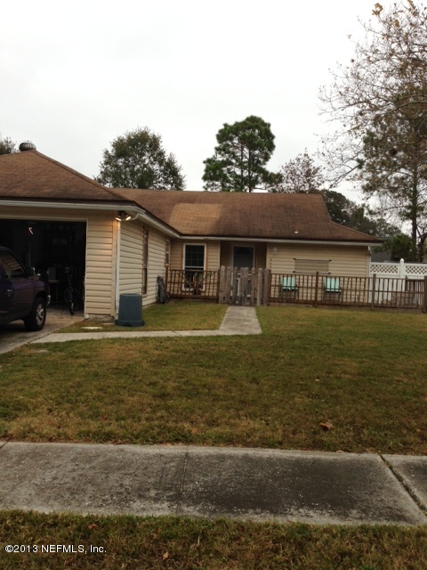 2441 Wattle Tree Road East Jacksonville, FL 32246 - Photo 1 of 13 a front view of a house with garden