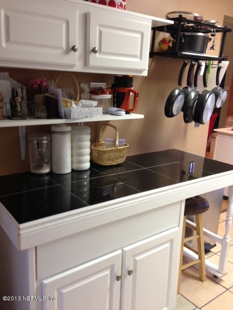 2441 Wattle Tree Road East Jacksonville, FL 32246 - Photo 3 of 13 a close view of shoes and cabinets