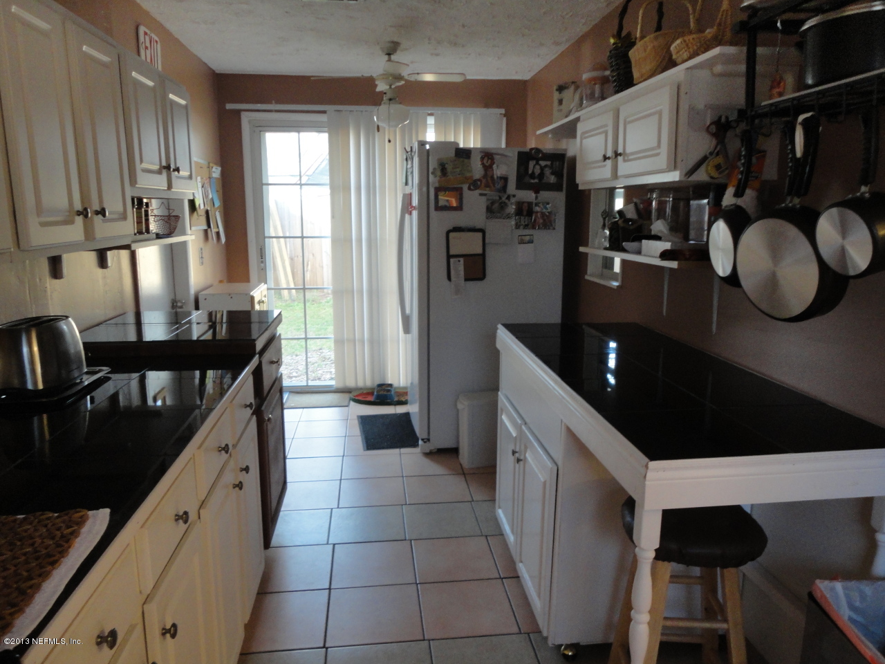 2441 Wattle Tree Road East Jacksonville, FL 32246 - Photo 4 of 13 a kitchen with stainless steel appliances kitchen island granite countertop a refrigerator and a stove top oven