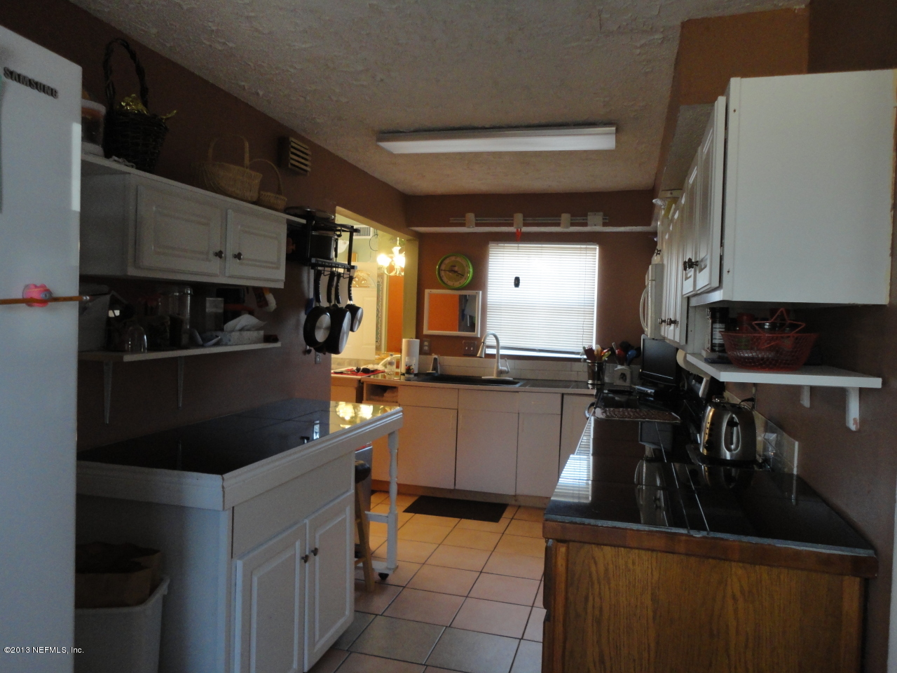 2441 Wattle Tree Road East Jacksonville, FL 32246 - Photo 5 of 13 a kitchen with stainless steel appliances kitchen island granite countertop a refrigerator and a stove top oven