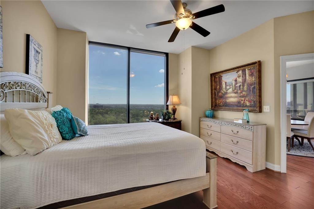 2828 Peachtree Road Northwest, Unit 1901 Atlanta, GA 30305 - Photo 16 of 35 a bedroom with a large bed and a chandelier