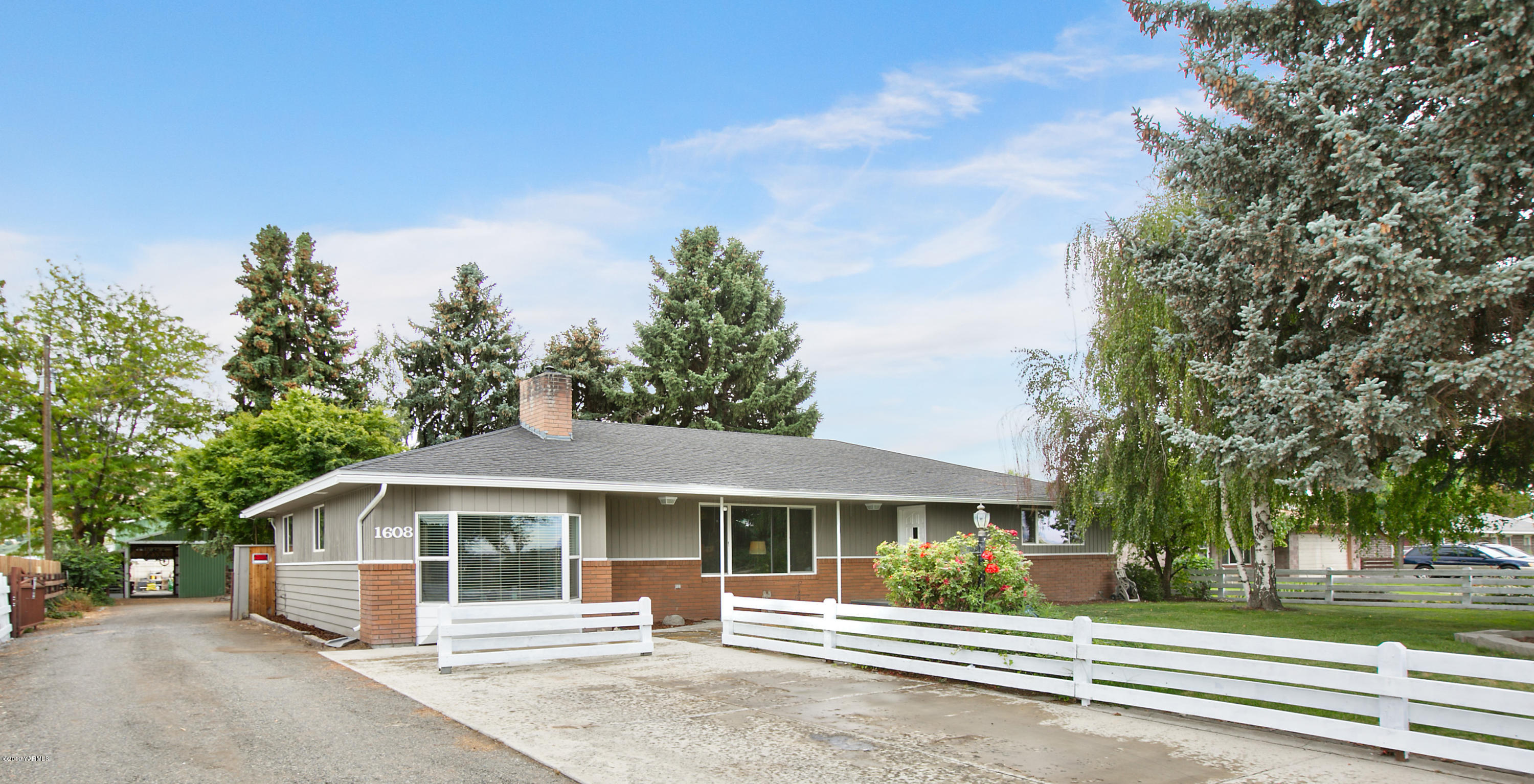 1608 Ahtanum Road Union Gap, WA 98903 - Photo 1 of 18 a front view of a house with a garden