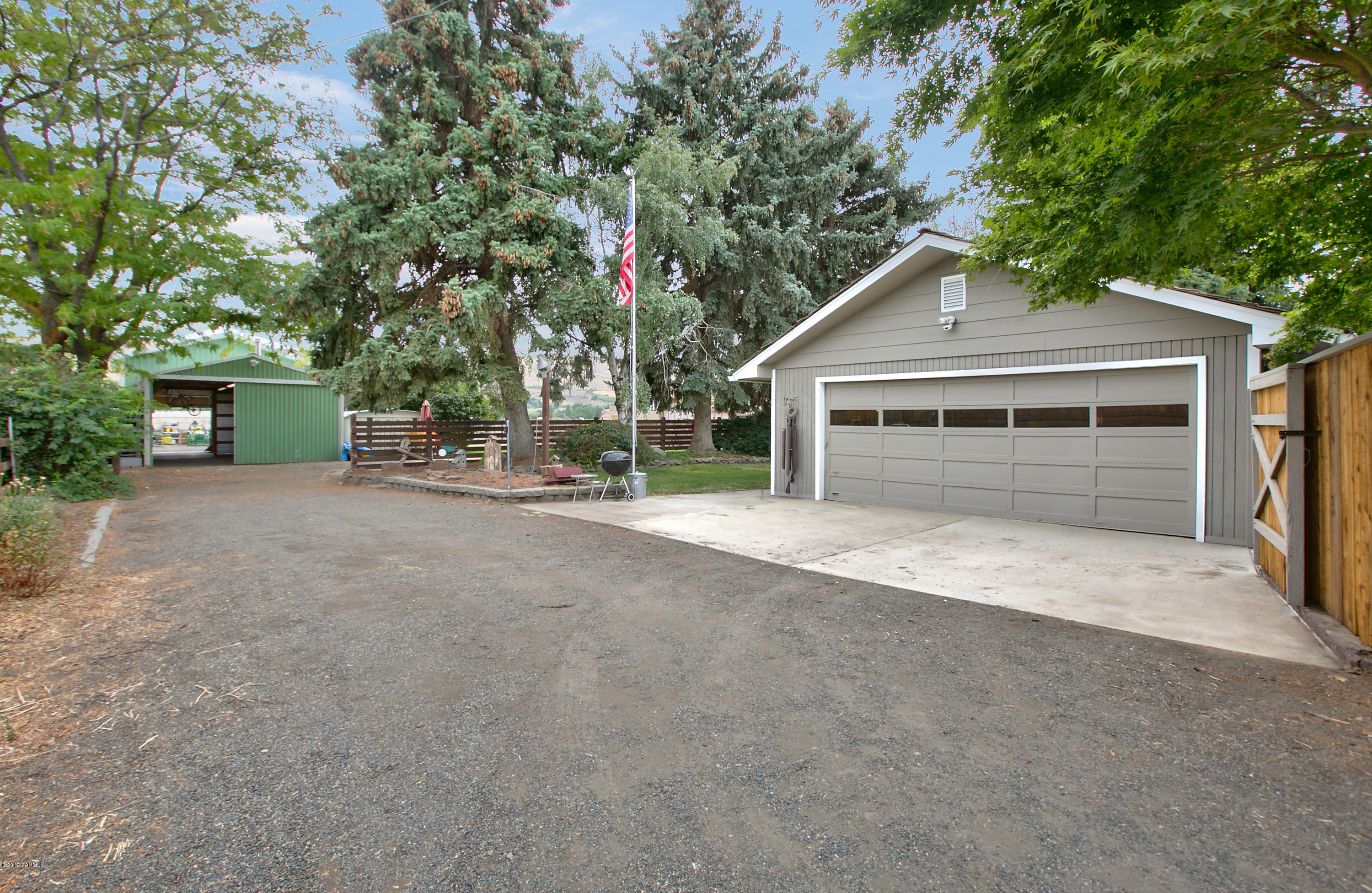 1608 Ahtanum Road Union Gap, WA 98903 - Photo 2 of 18 a view of a house with a yard and garage