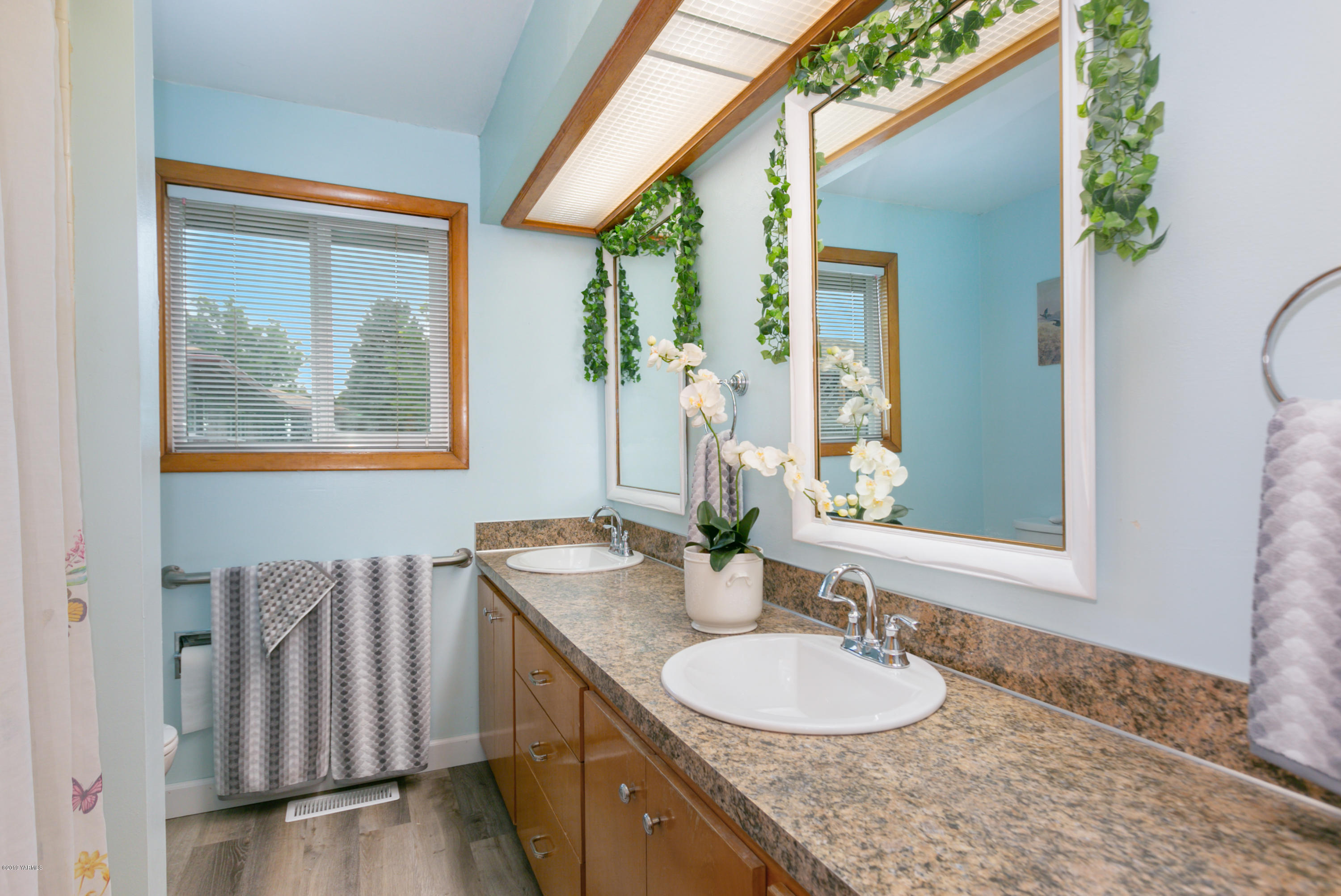 1608 Ahtanum Road Union Gap, WA 98903 - Photo 13 of 18 a bathroom with a granite countertop sink and a mirror