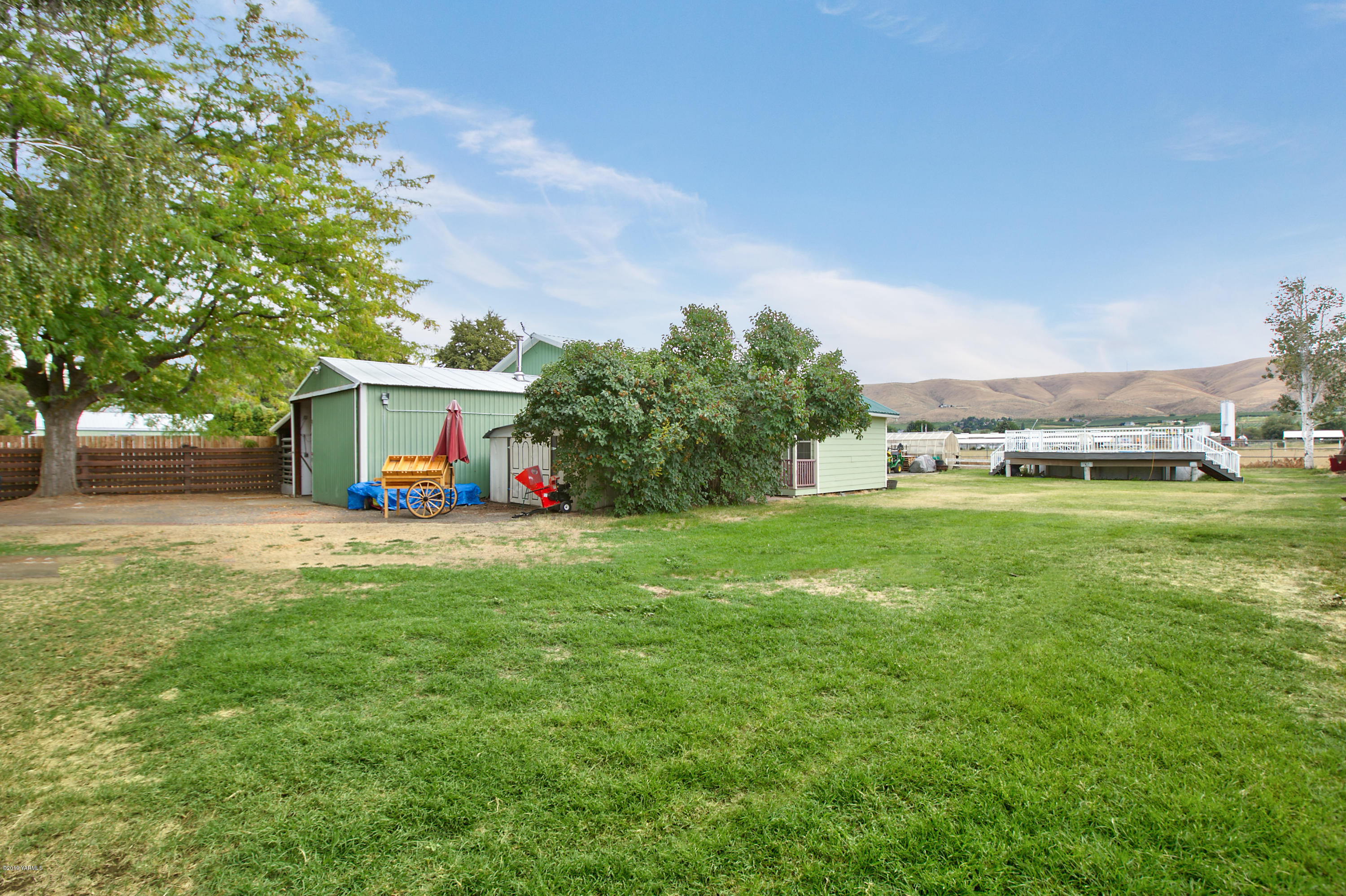 1608 Ahtanum Road Union Gap, WA 98903 - Photo 3 of 18 a front view of a house with a yard and a garage