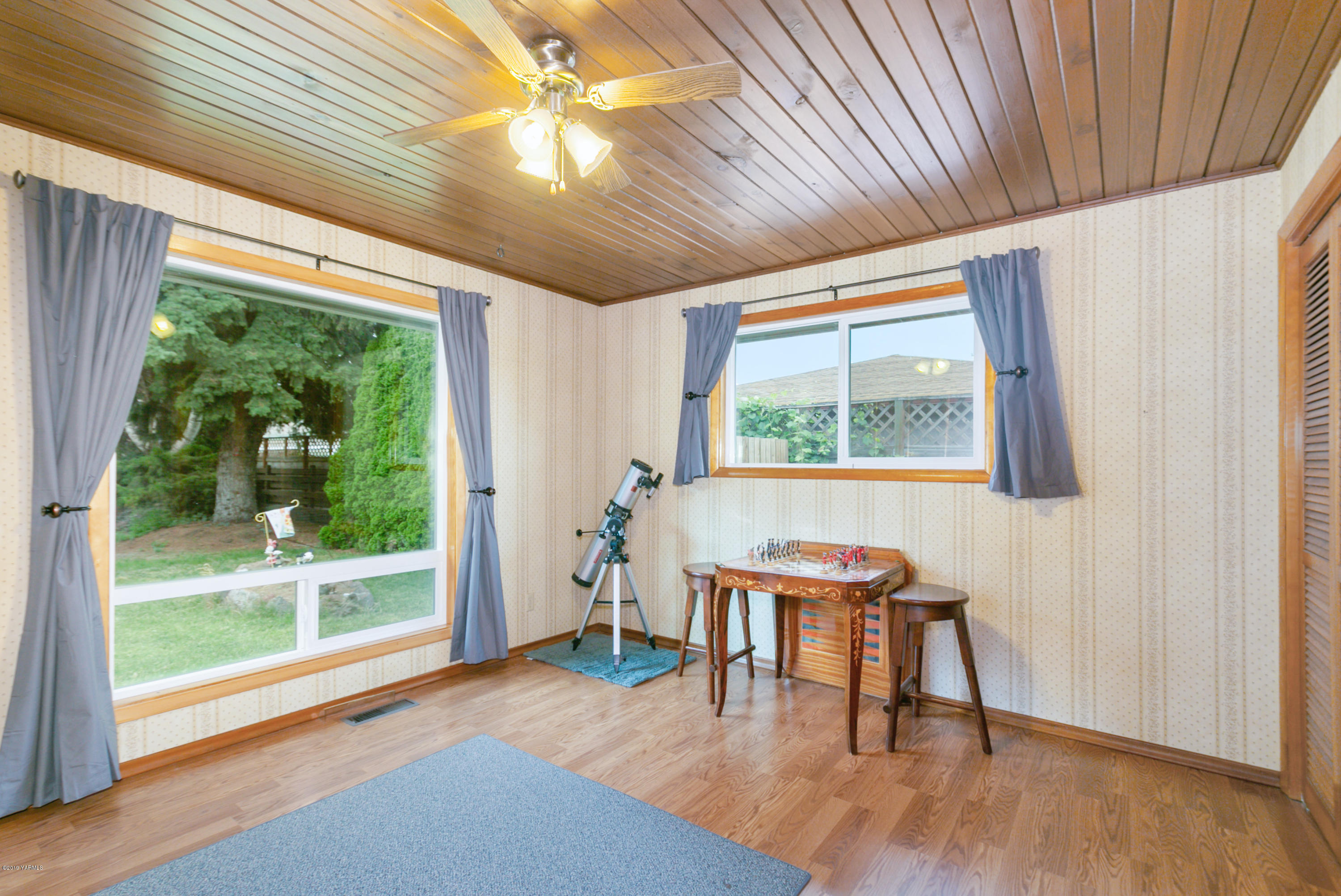 1608 Ahtanum Road Union Gap, WA 98903 - Photo 10 of 18 a dining room with wooden floor a chandelier a glass table and chairs