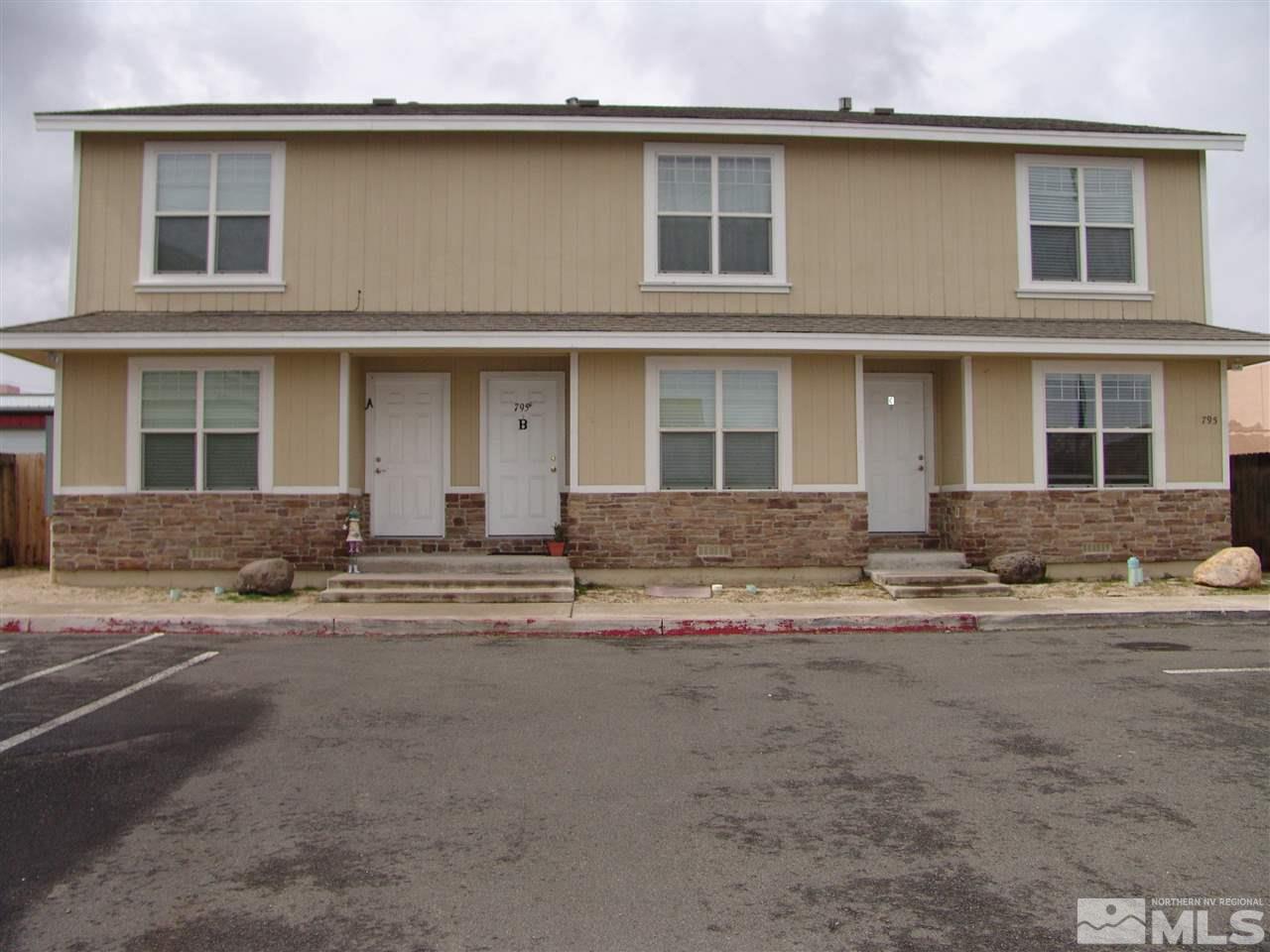 795 Montello Street Reno, NV 89512 - Photo 1 of 13 a front view of a house with a road