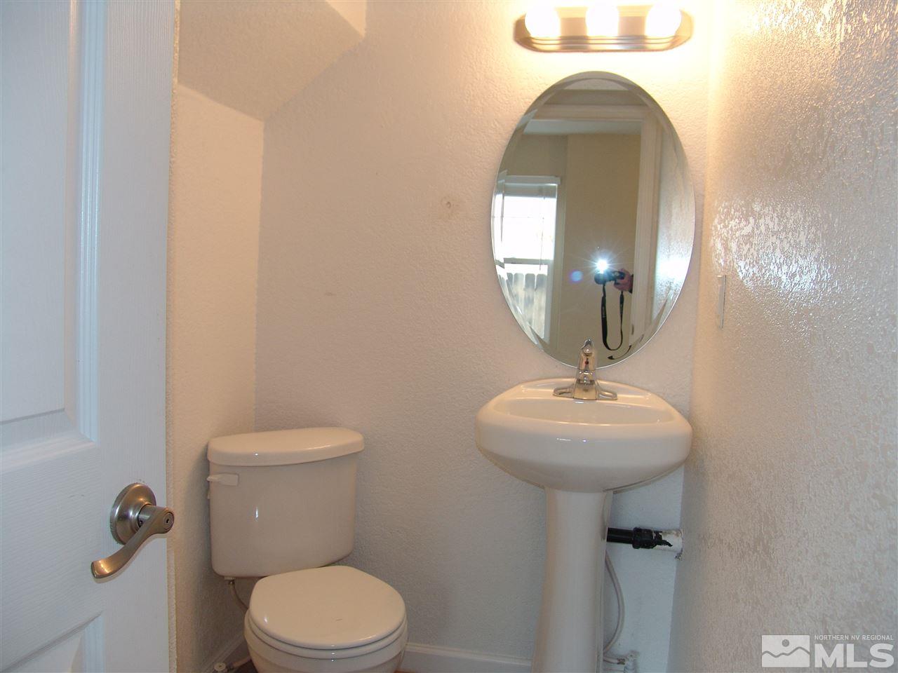 795 Montello Street Reno, NV 89512 - Photo 8 of 13 a bathroom with a toilet a sink and mirror