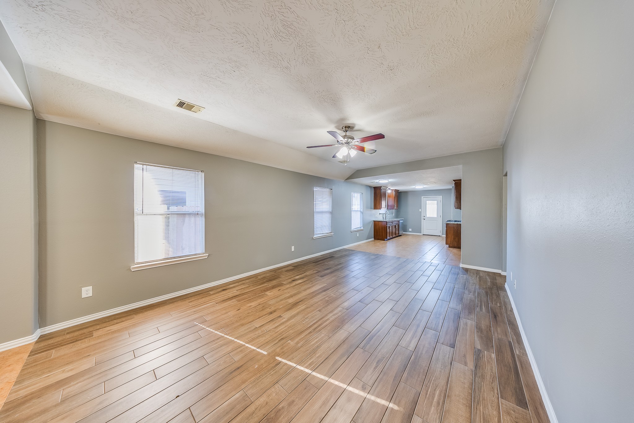 21927 Octavia Way Houston, TX 77073 - Photo 11 of 28 Living room with wood-look flooring, combining style and durability for a warm, inviting, and easy-to-maintain space.