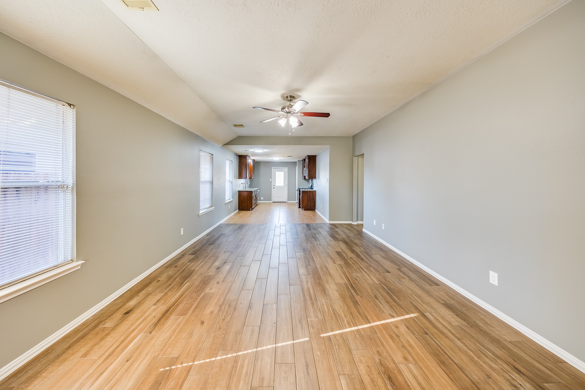 21927 Octavia Way Houston, TX 77073 - Photo 12 of 28 Living room with direct access to the kitchen, creating a seamless flow perfect for entertaining and family gatherings.