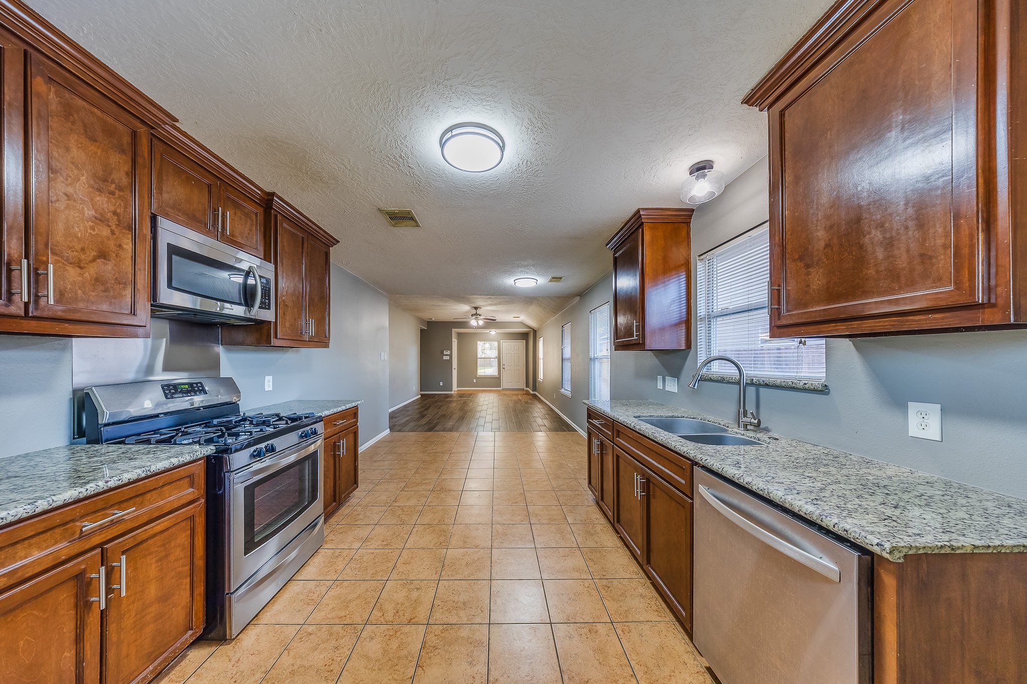 21927 Octavia Way Houston, TX 77073 - Photo 3 of 28 Wood-look kitchen featuring durable finishes, modern style, and warm tones that create an inviting and functional cooking space.