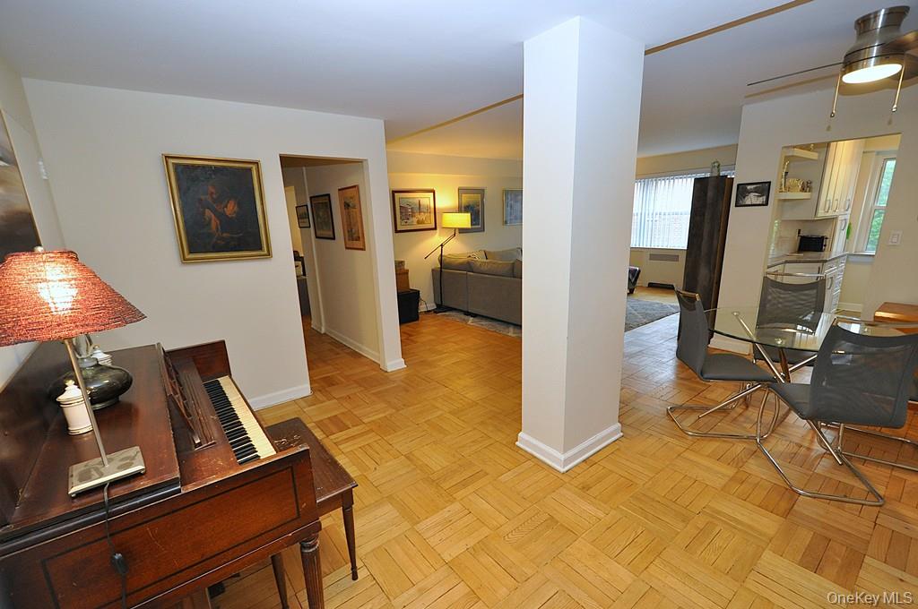 235 Garth Road, Unit A5B Scarsdale, NY 10583 - Photo 31 of 47 a view of a living room with furniture and a flat screen tv