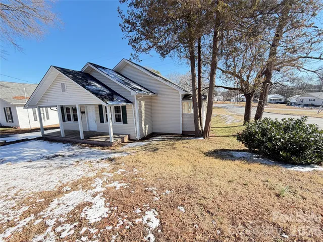 a view of a house with a yard covered in snow