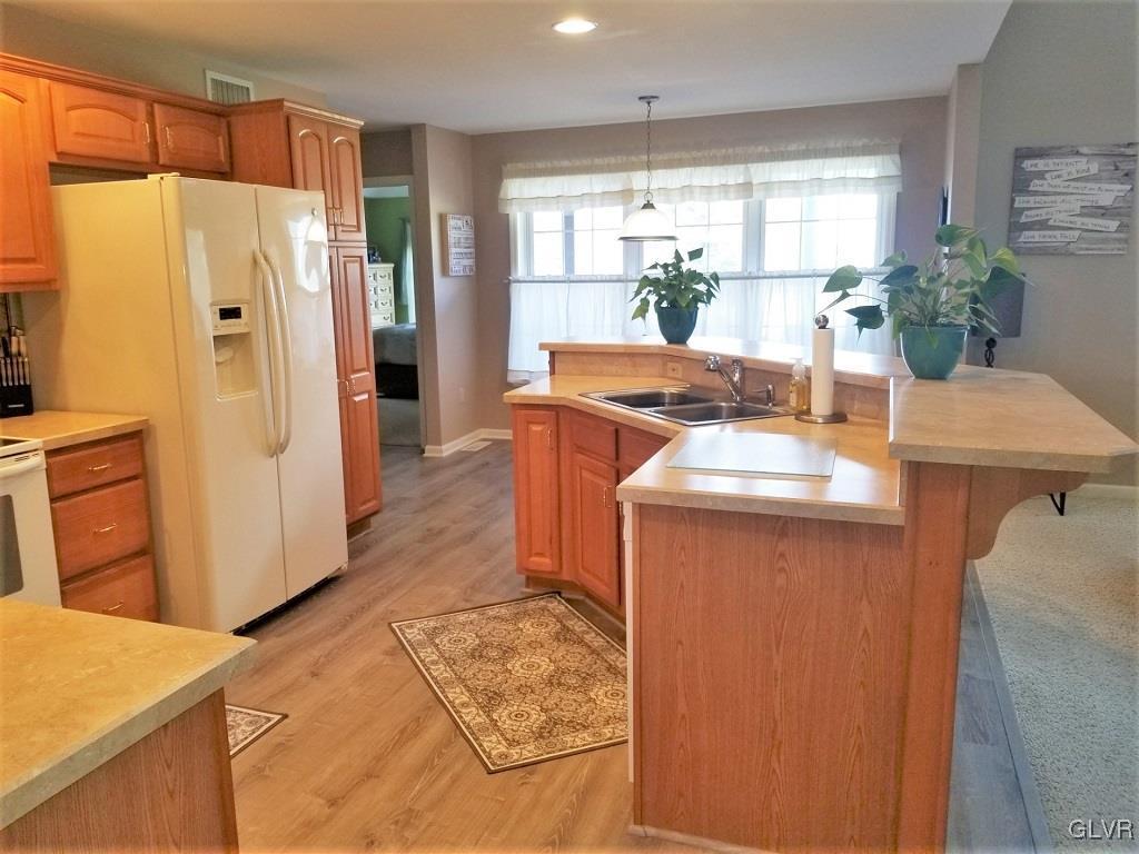 1032 Bushkill Center Road Wind Gap, PA 18091 - Photo 19 of 47 a kitchen with stainless steel appliances a refrigerator a sink a stove a dining table and chairs