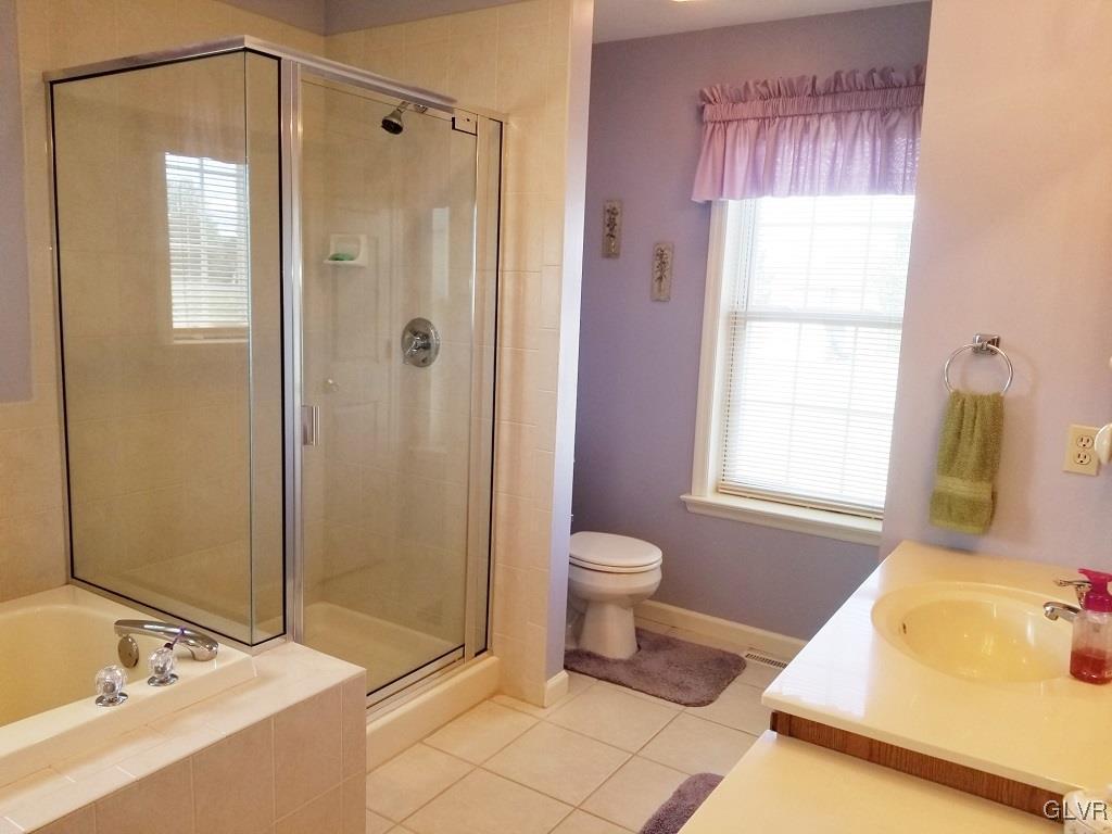 1032 Bushkill Center Road Wind Gap, PA 18091 - Photo 27 of 47 a bathroom with a tub shower sink and a toilet