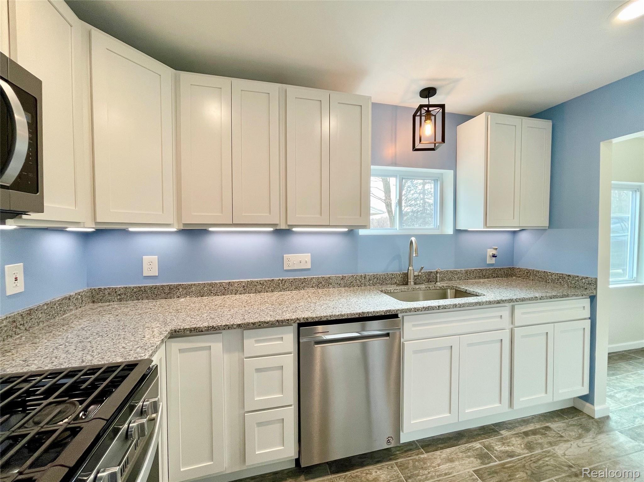 9089 Beech Daly Road Taylor, MI 48180 - Photo 17 of 42 Remodeled kitchen with custom soft-close cabinets, granite counters, under-mount cabinet lighting, Whirlpool stainless dishwasher.