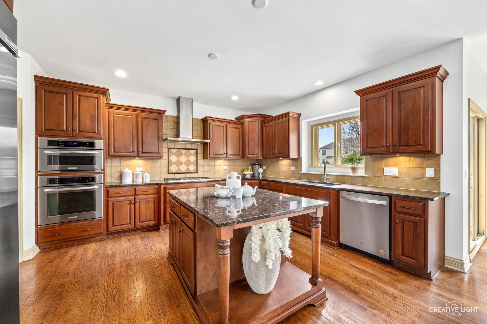 1887 Snead Street Bolingbrook, IL 60490 - Photo 12 of 49 a kitchen with stainless steel appliances granite countertop a stove a sink dishwasher and a refrigerator