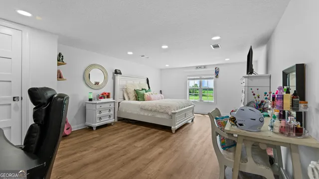 a view of a livingroom with furniture and floor to ceiling window