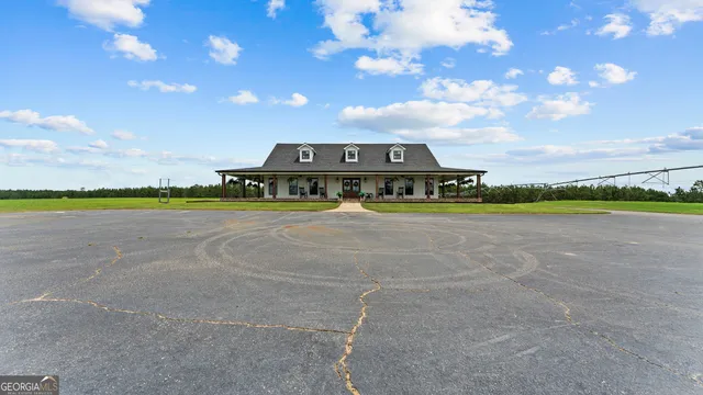 a room with stainless steel appliances kitchen island granite countertop furniture and a view of kitchen