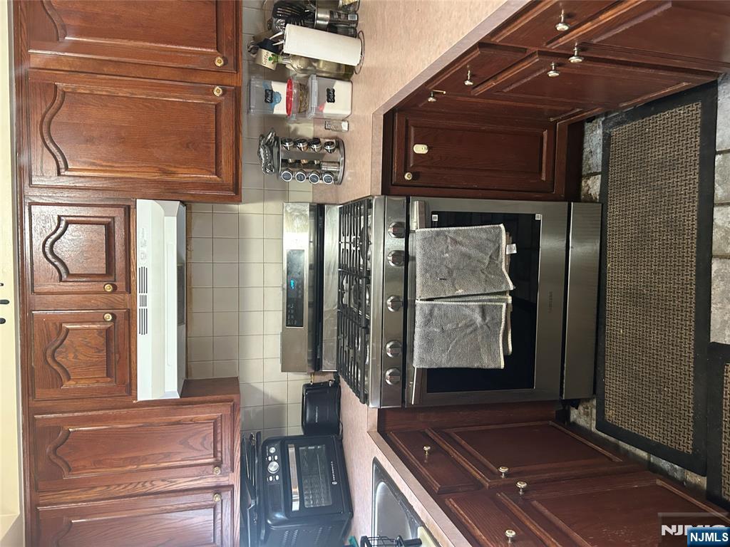 382 Lakeview Avenue, Unit 1 Clifton, NJ 07011 - Photo 11 of 13 a kitchen with a stove and cabinets