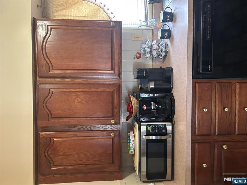 382 Lakeview Avenue, Unit 1 Clifton, NJ 07011 - Photo 12 of 13 a kitchen with stainless steel appliances granite countertop a sink a stove and cabinets