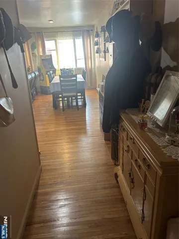 a view of a living room with furniture and wooden floor