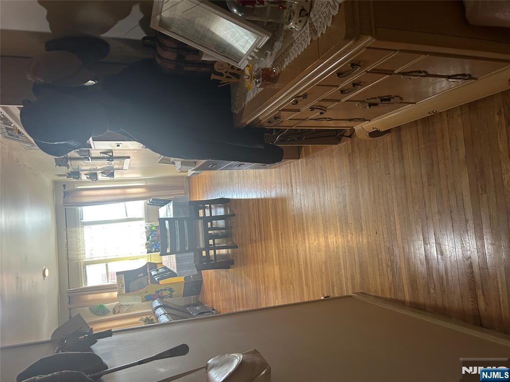 382 Lakeview Avenue, Unit 1 Clifton, NJ 07011 - Photo 3 of 13 a view of a living room with furniture and wooden floor