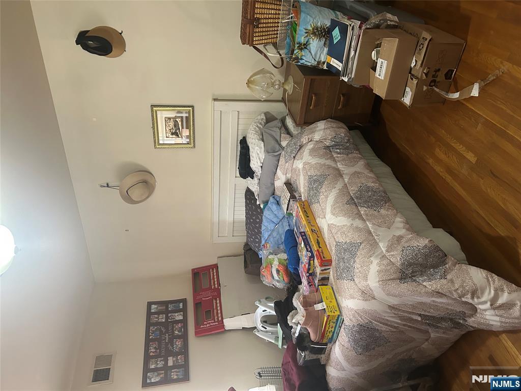 382 Lakeview Avenue, Unit 1 Clifton, NJ 07011 - Photo 7 of 13 a bedroom with two beds and painting on the wall