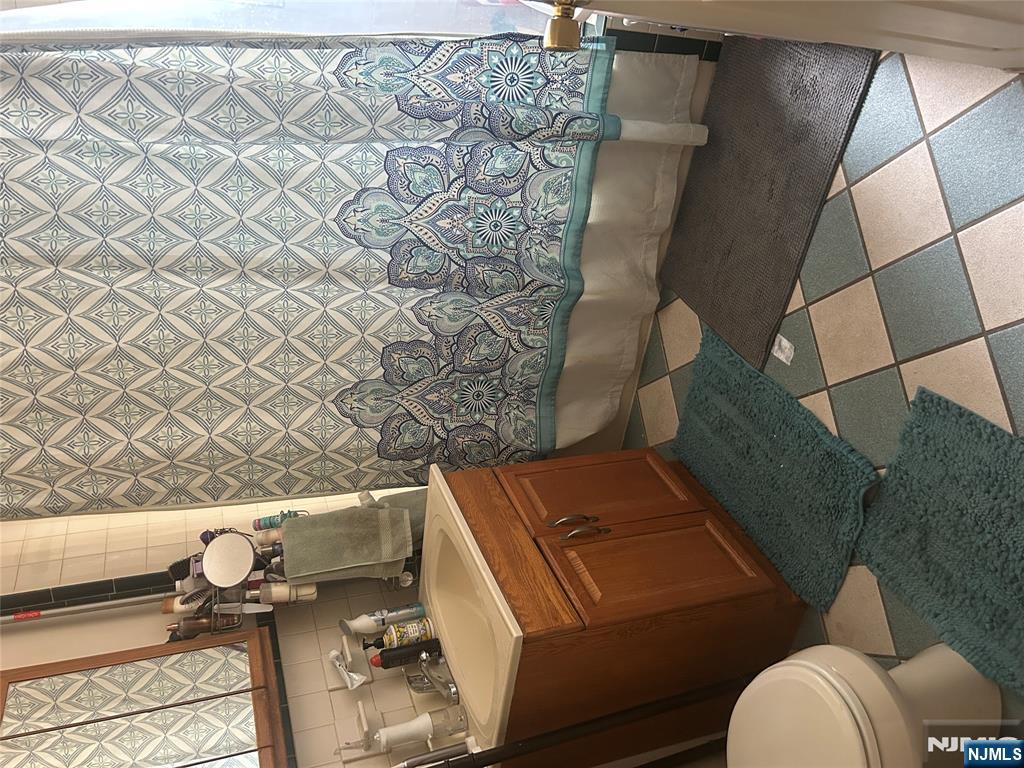 382 Lakeview Avenue, Unit 1 Clifton, NJ 07011 - Photo 8 of 13 a bathroom with a sink and a toilet