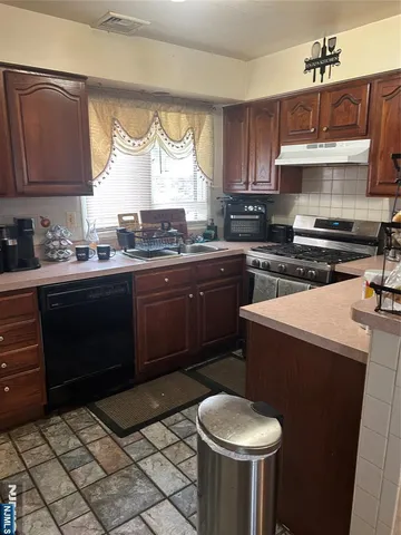 a kitchen with a stove and cabinets