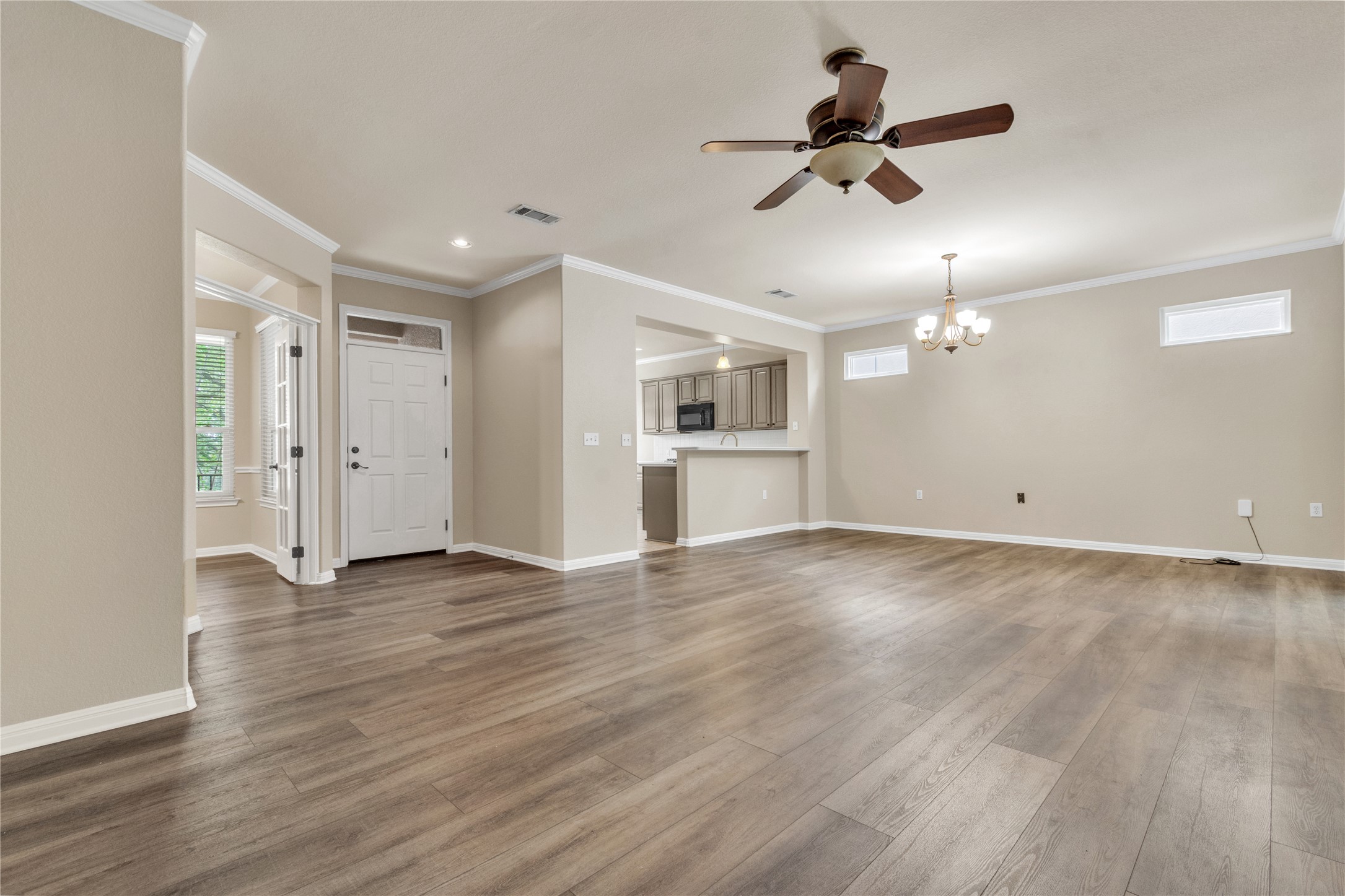 409 Rio Grande Loop Georgetown, TX 78633 - Photo 13 of 26 An inviting open-concept living space features warm wood flooring and a kitchen with modern appliances.